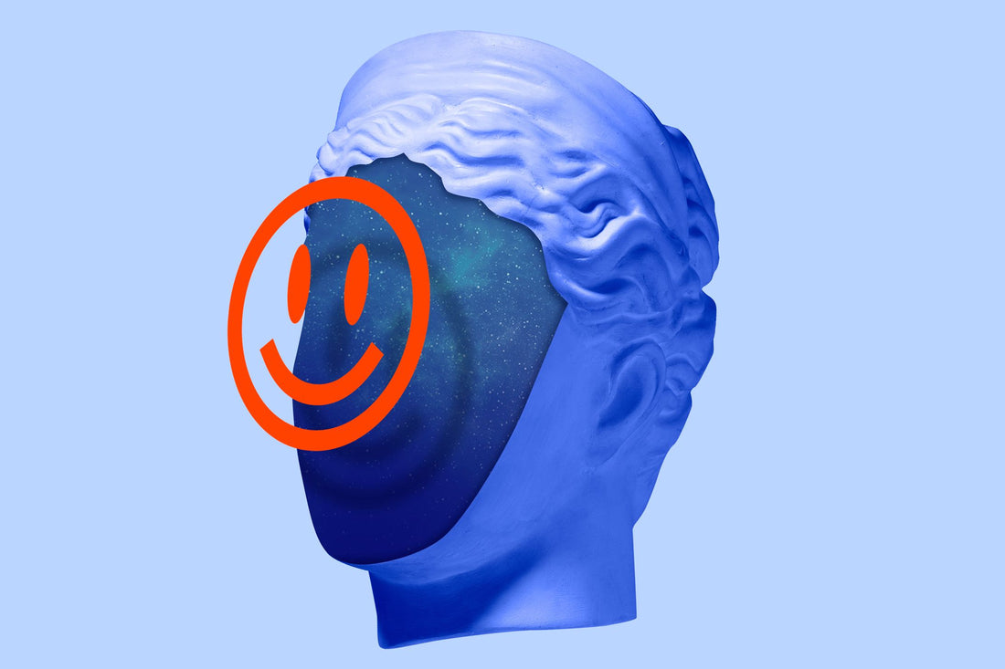A graphic red smiley face in front of a contemporary style renaissance sculptured head in blue.